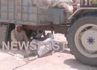 In this mandi of district, farmers escape from sun by sitting under the trolleys